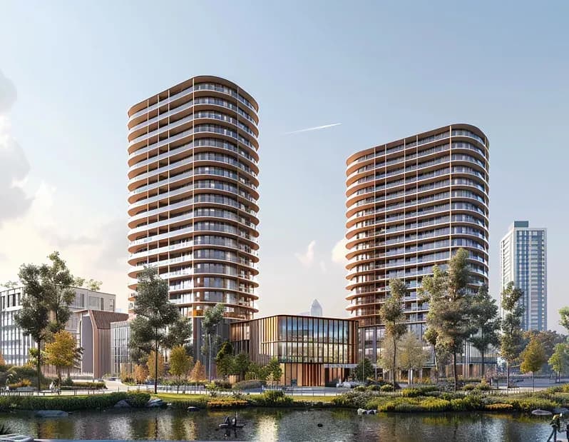 Twin curved residential towers beside a landscaped lake